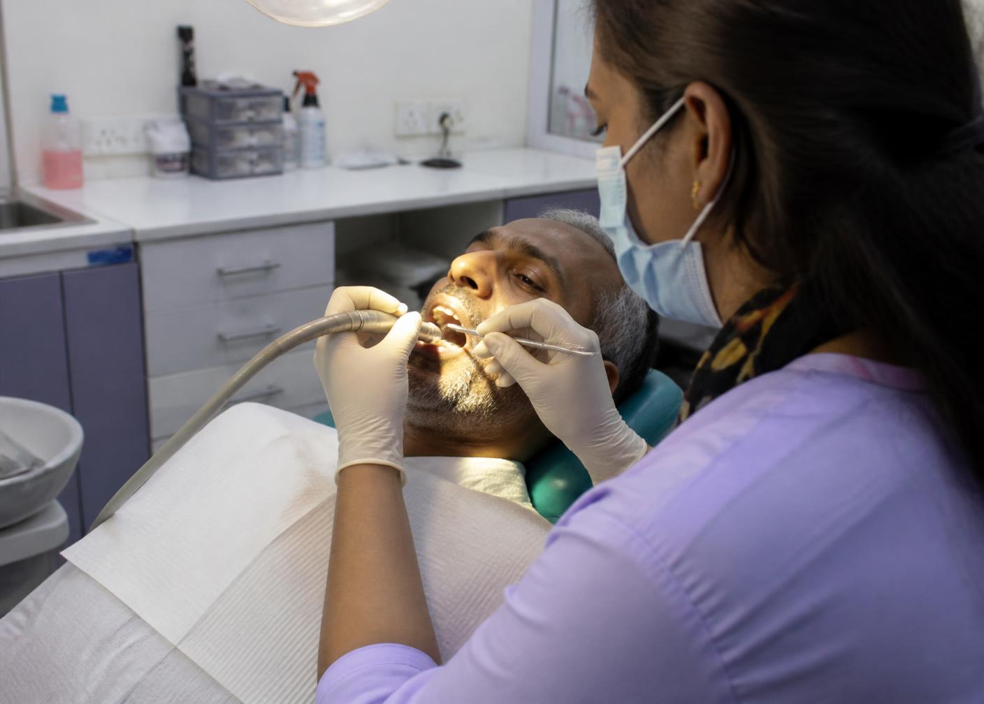 Dental hygienist carrying out a scaling and polishing treatment